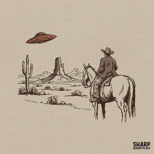 Vintage sketch style digital design of a cowboy on horseback looking at a flying saucer hovering over desert buttes and a saguaro cactus.