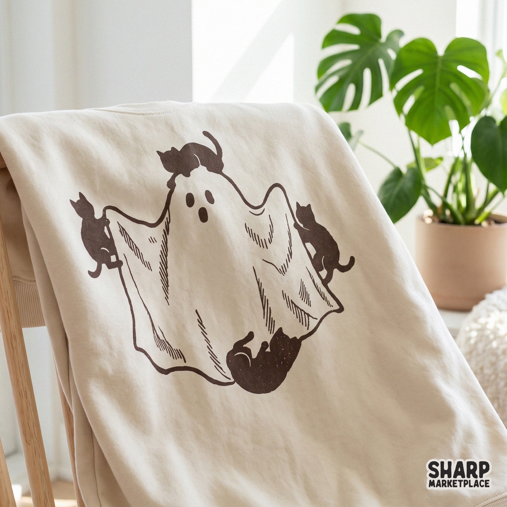 Three black cats playing with a sheet ghost, cute spooky season digital art for Halloween shirts and fall decor prints