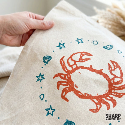 Trendy beach-themed illustration with a central orange crab and a teal starfish and shell border, ideal for summer shirts, stickers, and wall art.