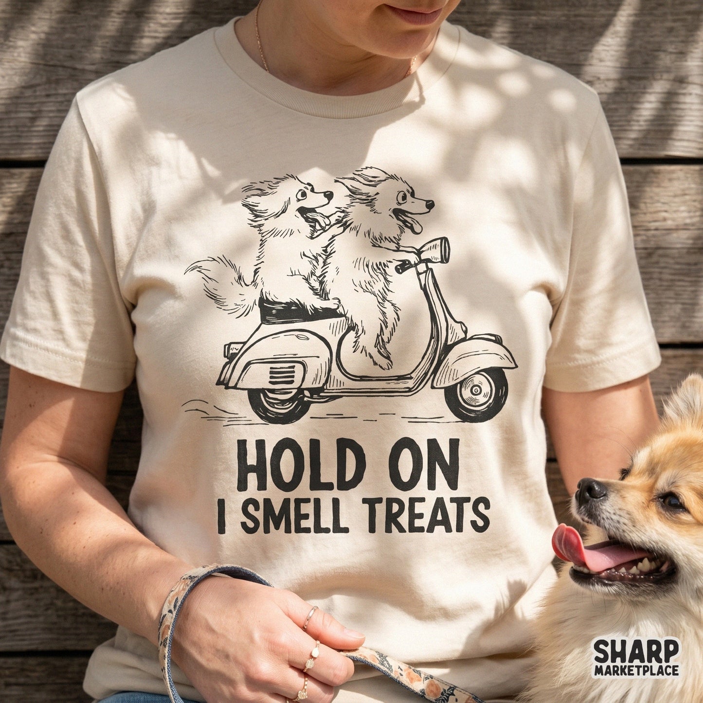 Whimsical illustration of two dogs on a scooter with windblown fur and tongues out, featuring the quote Hold On I Smell Treats for apparel printing.