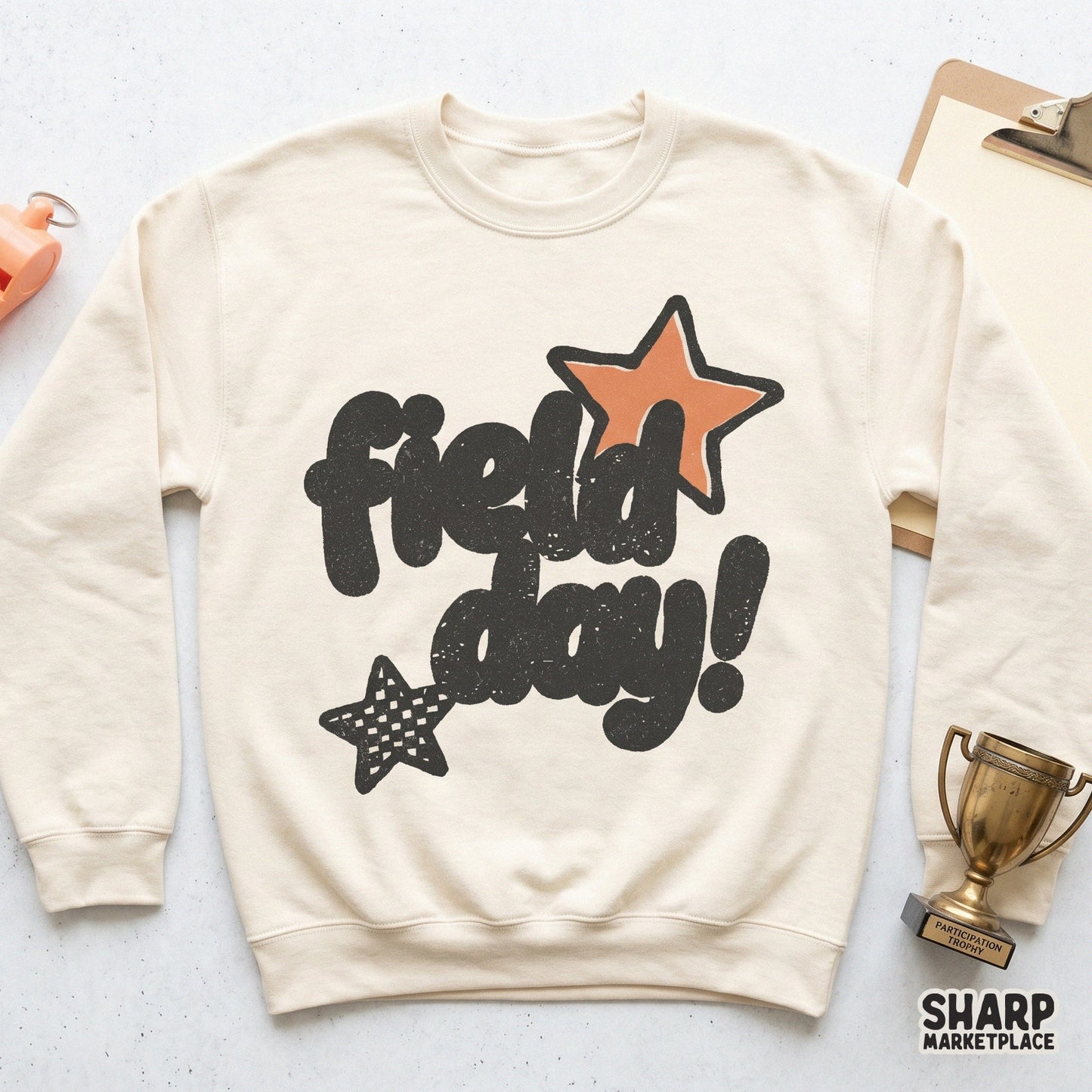 Printable school event design with Field Day in a bold, retro-inspired bubble font, accented by orange and patterned stars for DIY teacher apparel.