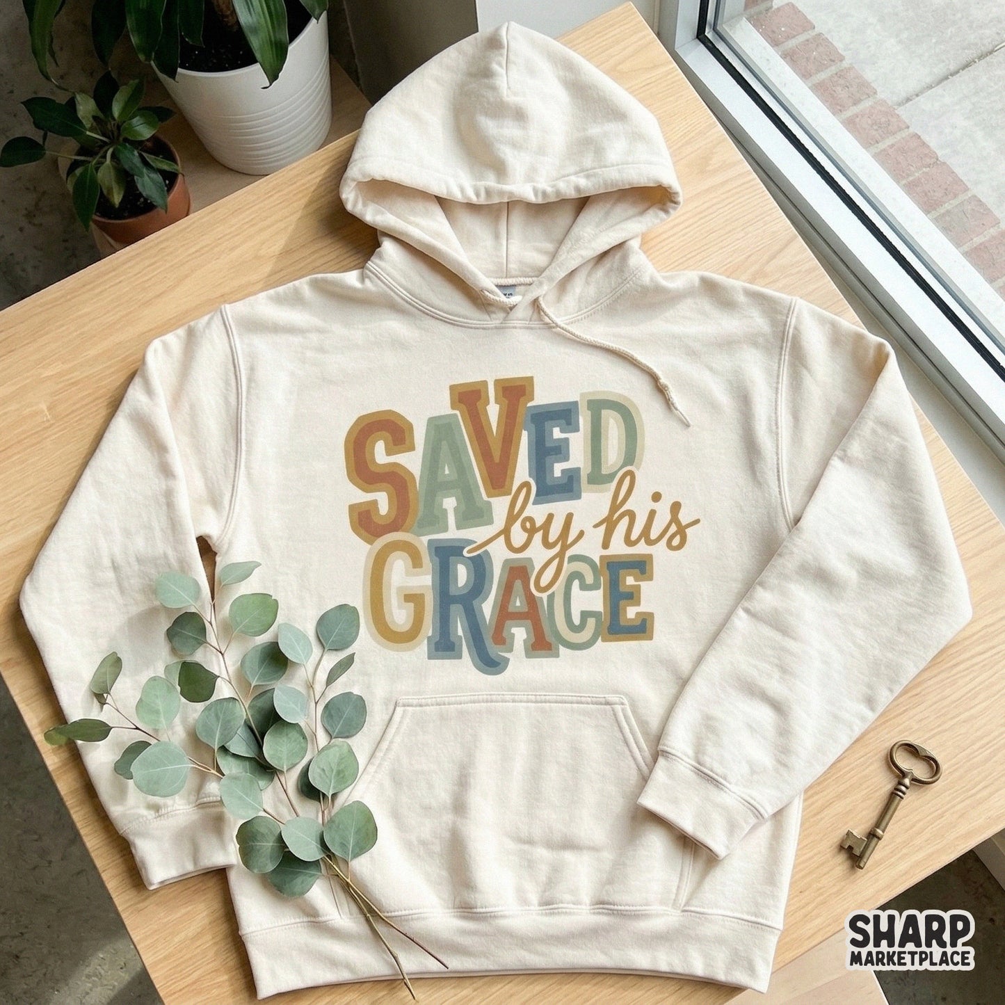Christian faith-themed digital design with the words Saved by his grace in a vintage, multi-colored block font style perfect for custom t-shirts.