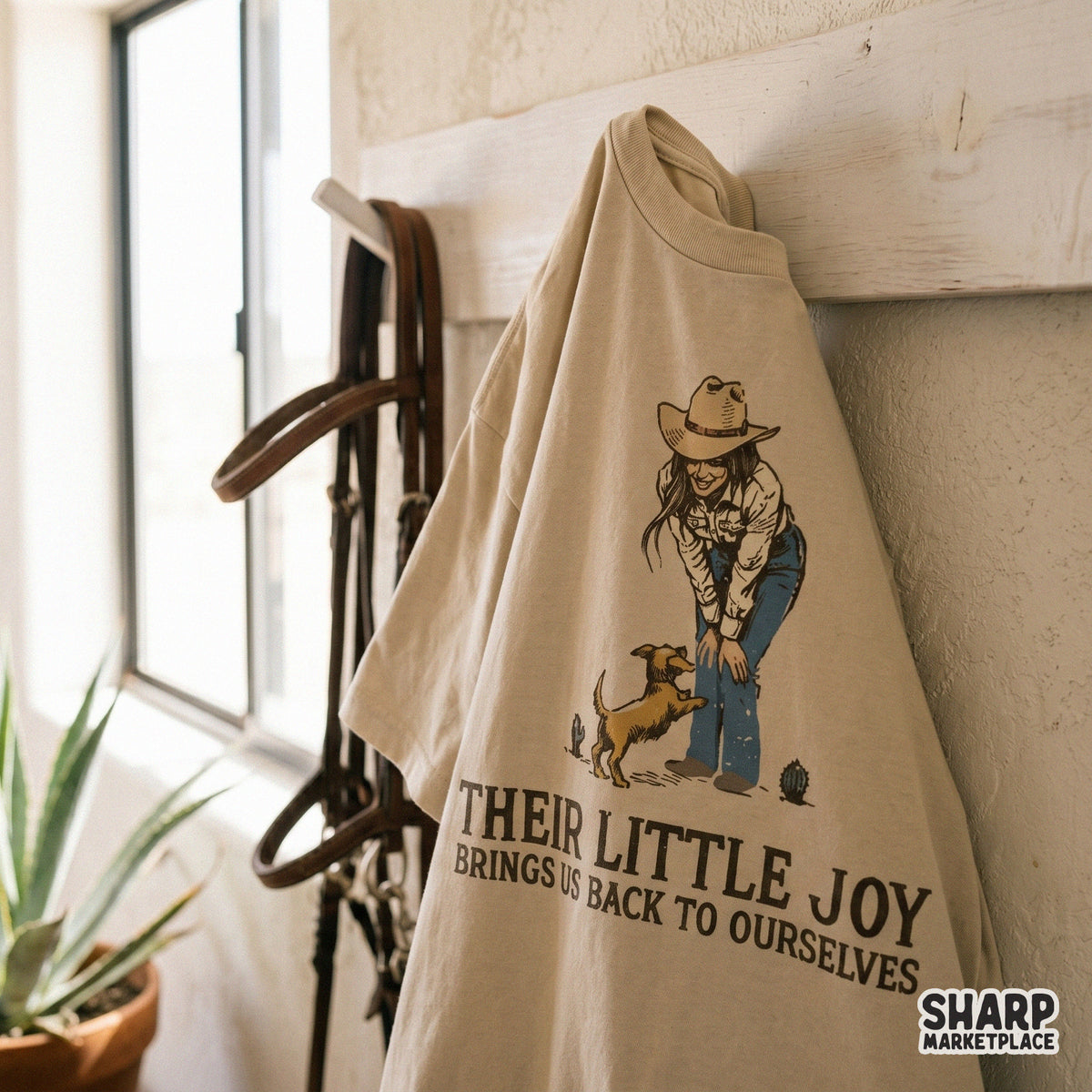 Digital download for DIY projects featuring a cowgirl and her pet in earth tones with vintage typography reading Their Little Joy Brings Us Back To Ourselves.
