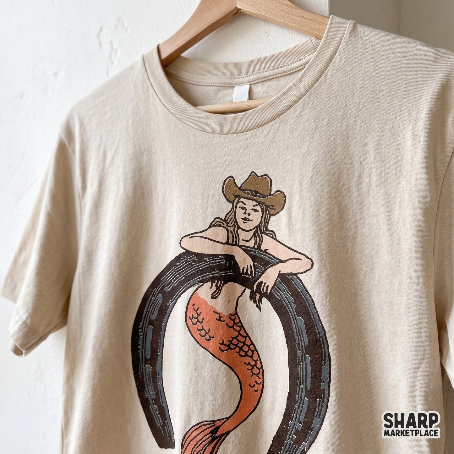 Retro cowgirl mermaid sitting in a horseshoe digital PNG for western country music apparel and beach rodeo designs