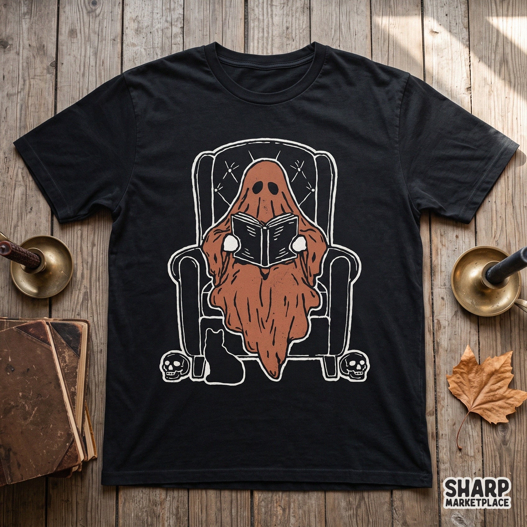 Cute ghost reading a book in an armchair sublimation PNG for cozy fall and halloween apparel designs