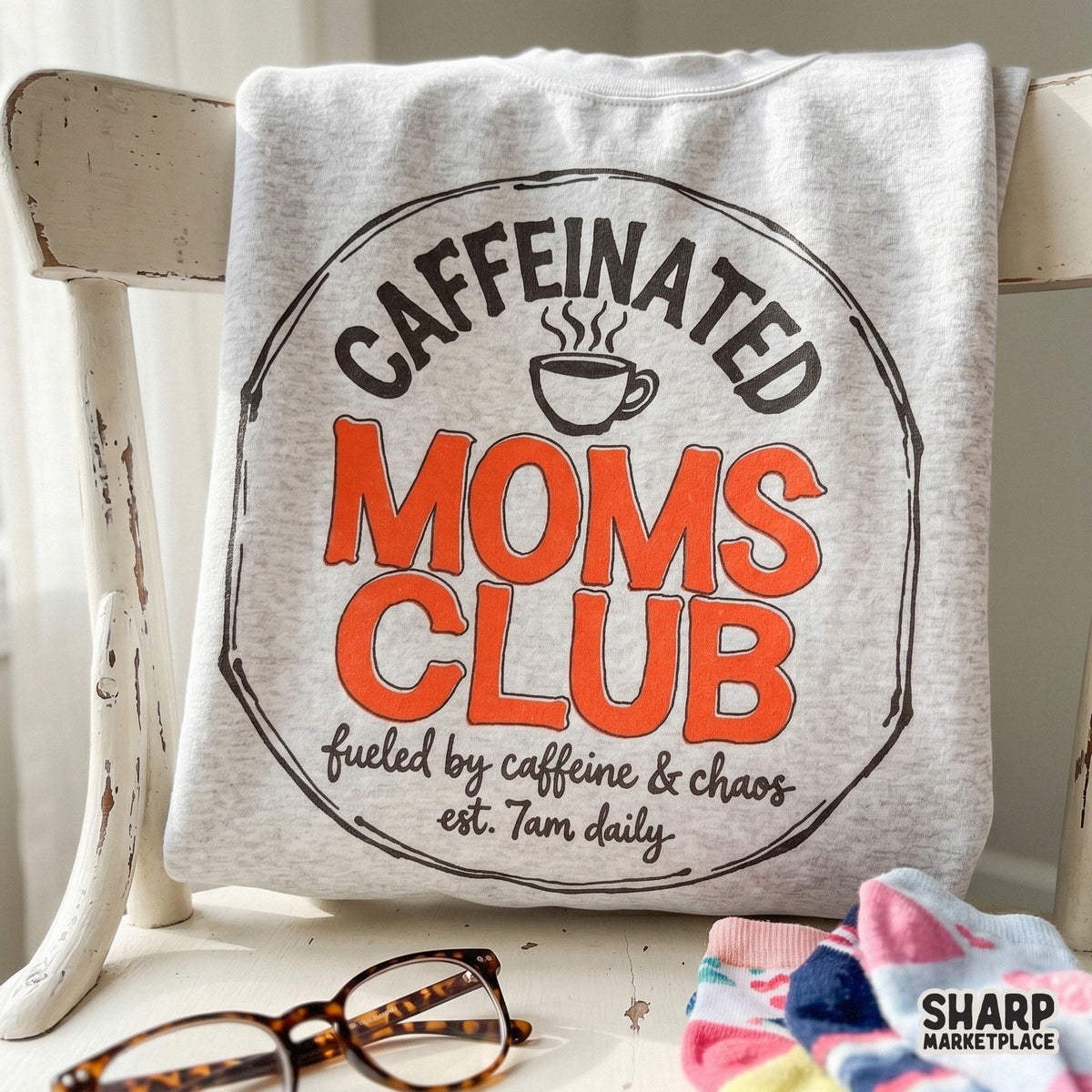 Digital sublimation graphic for apparel featuring a hand-drawn circular border, a coffee cup icon, and humorous text about motherhood and coffee.