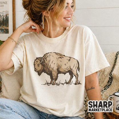 A retro buffalo graphic printed on a cream-colored t-shirt, showcasing a hand-drawn prairie animal design perfect for rustic country fashion.