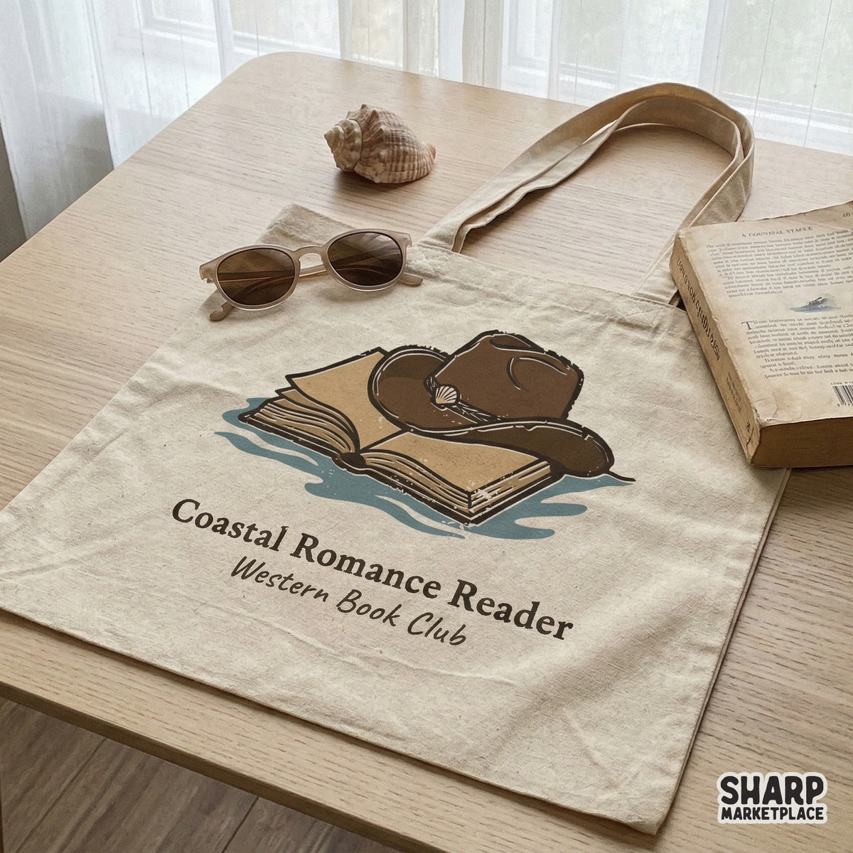 Sublimation PNG file for book lovers, featuring a hand-drawn cowboy hat, open book, and seashell with Coastal Romance Reader text for apparel.