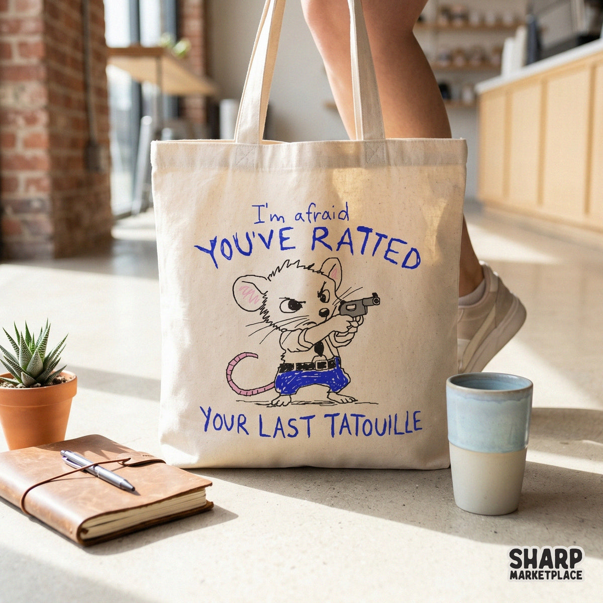 A canvas tote bag featuring a funny western mouse graphic in blue marker style, holding a gun with the sarcastic caption I am afraid you have ratted your last