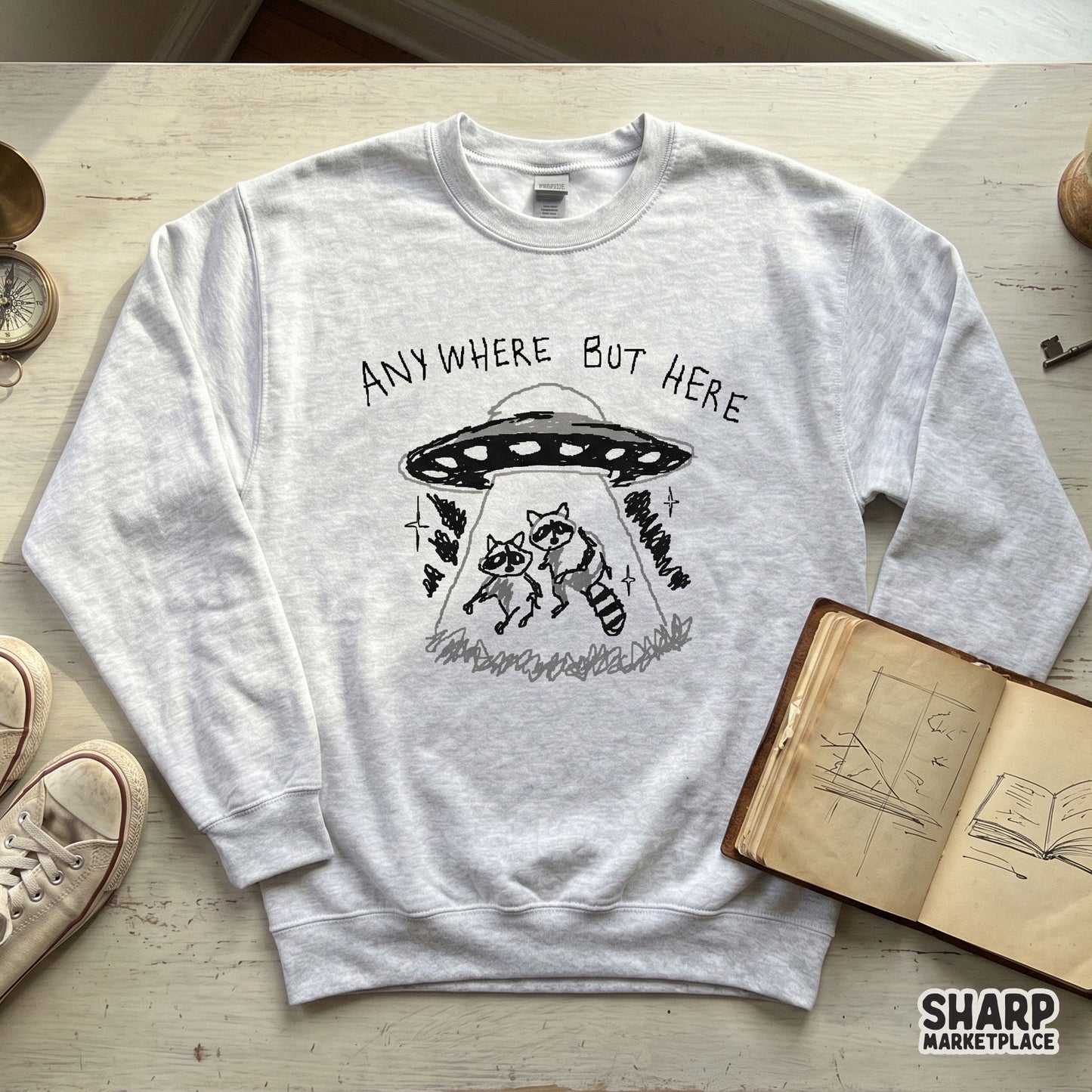 Retro-inspired digital art of two raccoons being beamed up into a flying saucer, featuring distressed typography for a sarcastic space meme aesthetic.