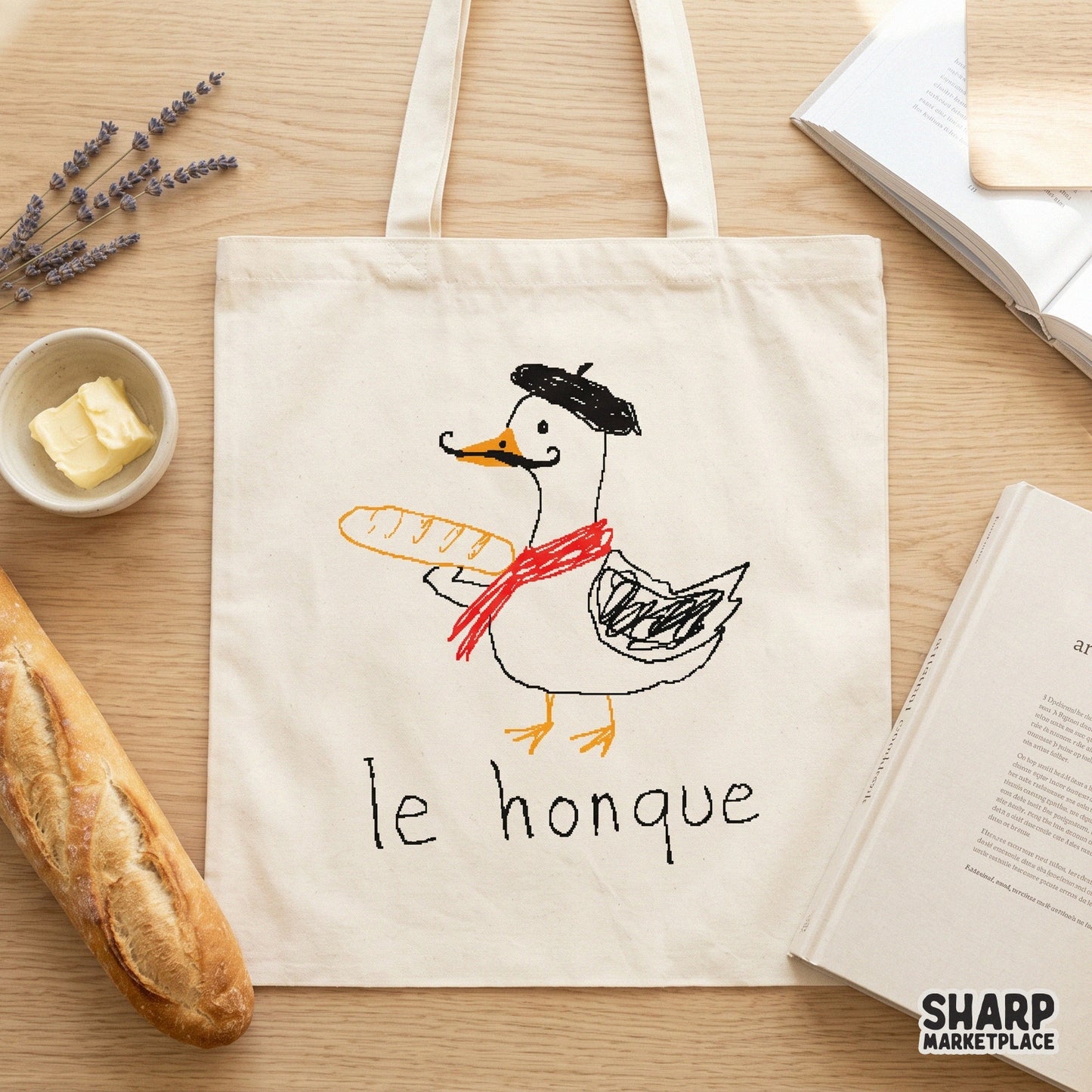 Quirky white goose wearing a red scarf and black beret, holding a crusty baguette with the text le honque, ideal for humorous DIY apparel and gifts.