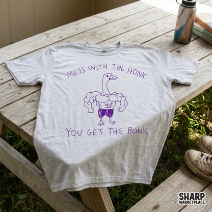 A grey t-shirt mockup featuring a purple sketch of a buff goose with a funny quote, perfect for gym apparel and sarcastic sublimation designs.