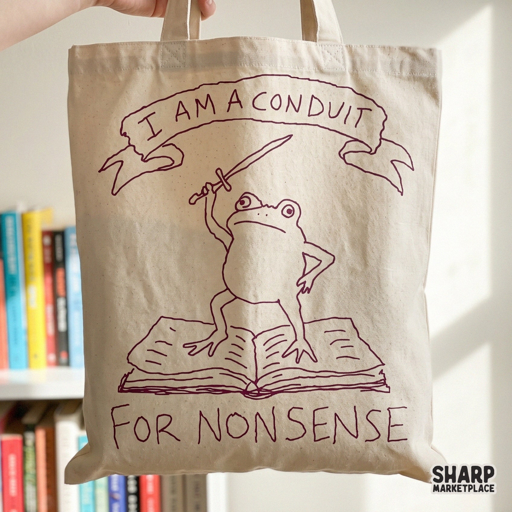 Sarcastic frog design with a sword and book, perfect for sublimation, stickers, or apparel featuring the quote I Am A Conduit For Nonsense.
