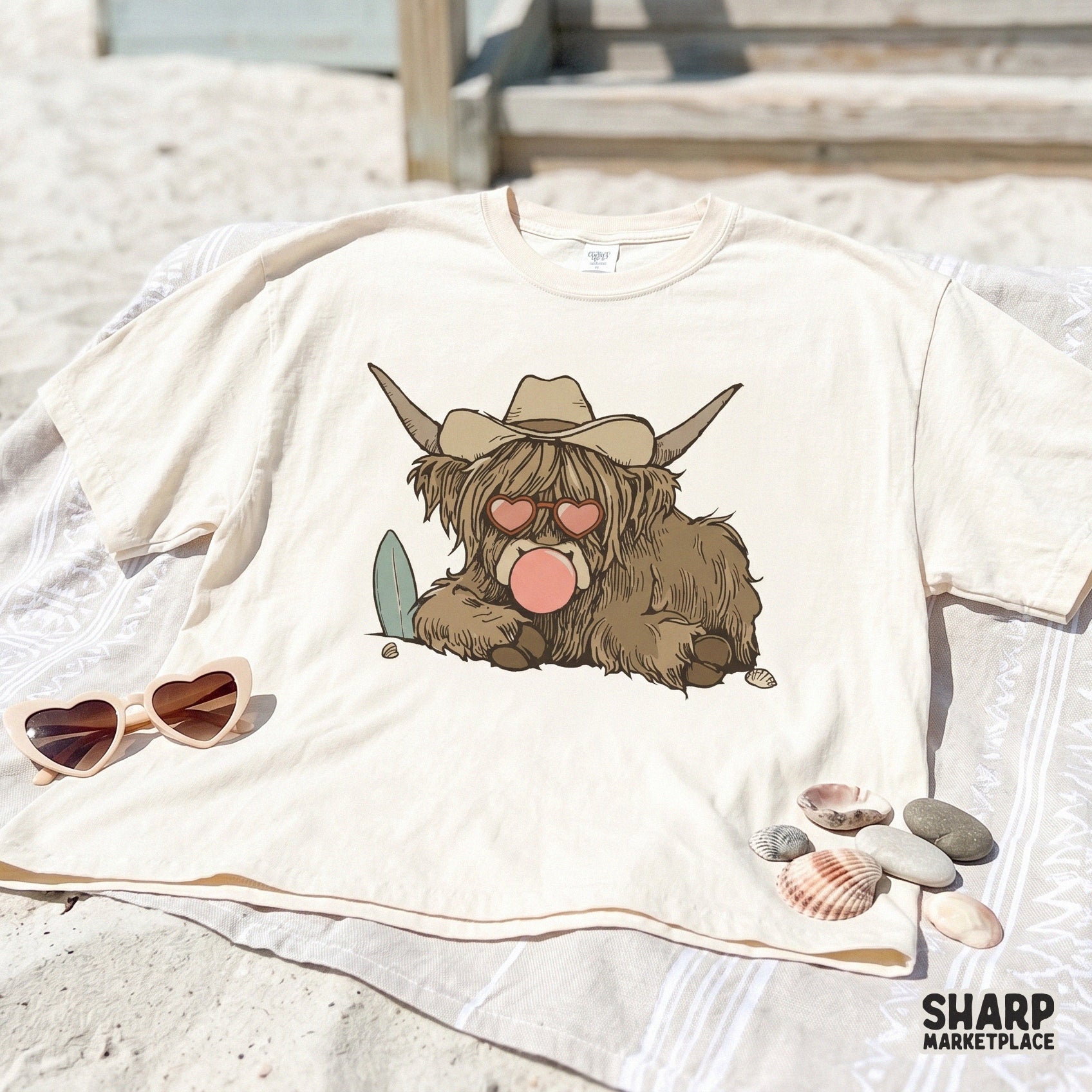 Digital illustration of a beach-loving highland cow with a surfboard, heart glasses, and bubblegum, ideal for custom t-shirts and apparel.