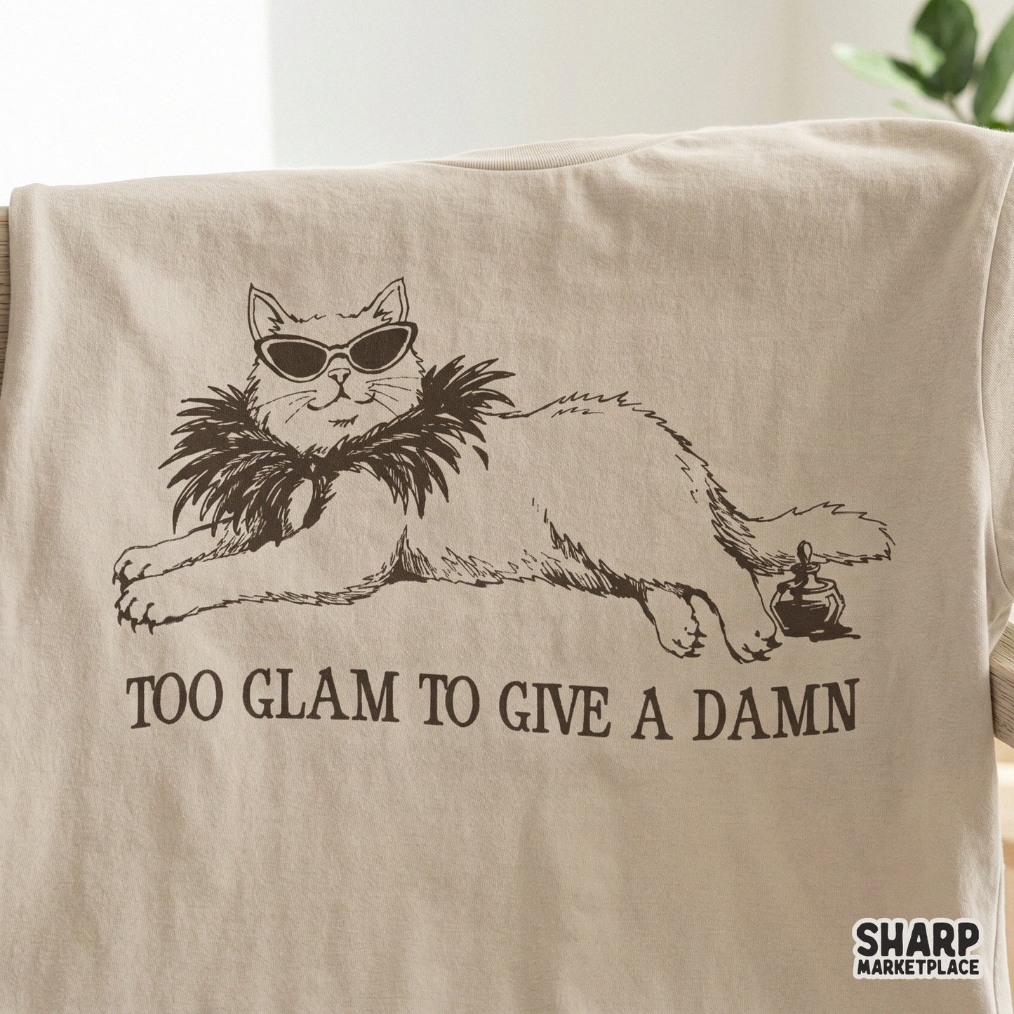 Digital illustration of a glamorous lounging cat with sunglasses and a perfume bottle, featuring the sarcastic quote Too Glam To Give A Damn.