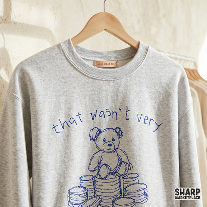 Retro style blue scribbled teddy bear sitting on money stacks with the sarcastic phrase That wasn't very cash money of you for DIY print projects.