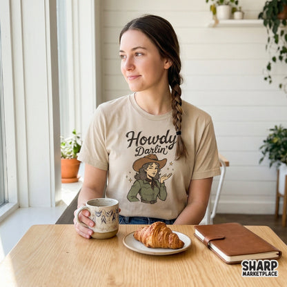Trendy cowgirl sublimation graphic on a shirt mockup featuring a winking woman in a cowboy hat with earthy green and brown tones and yellow stars.