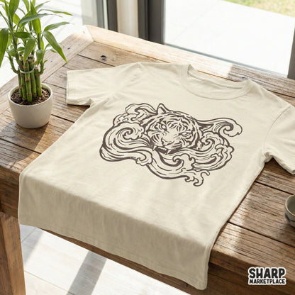 A digital design featuring a snarling tiger head surrounded by flowing wave motifs, displayed as a dark graphic on a light colored t-shirt.