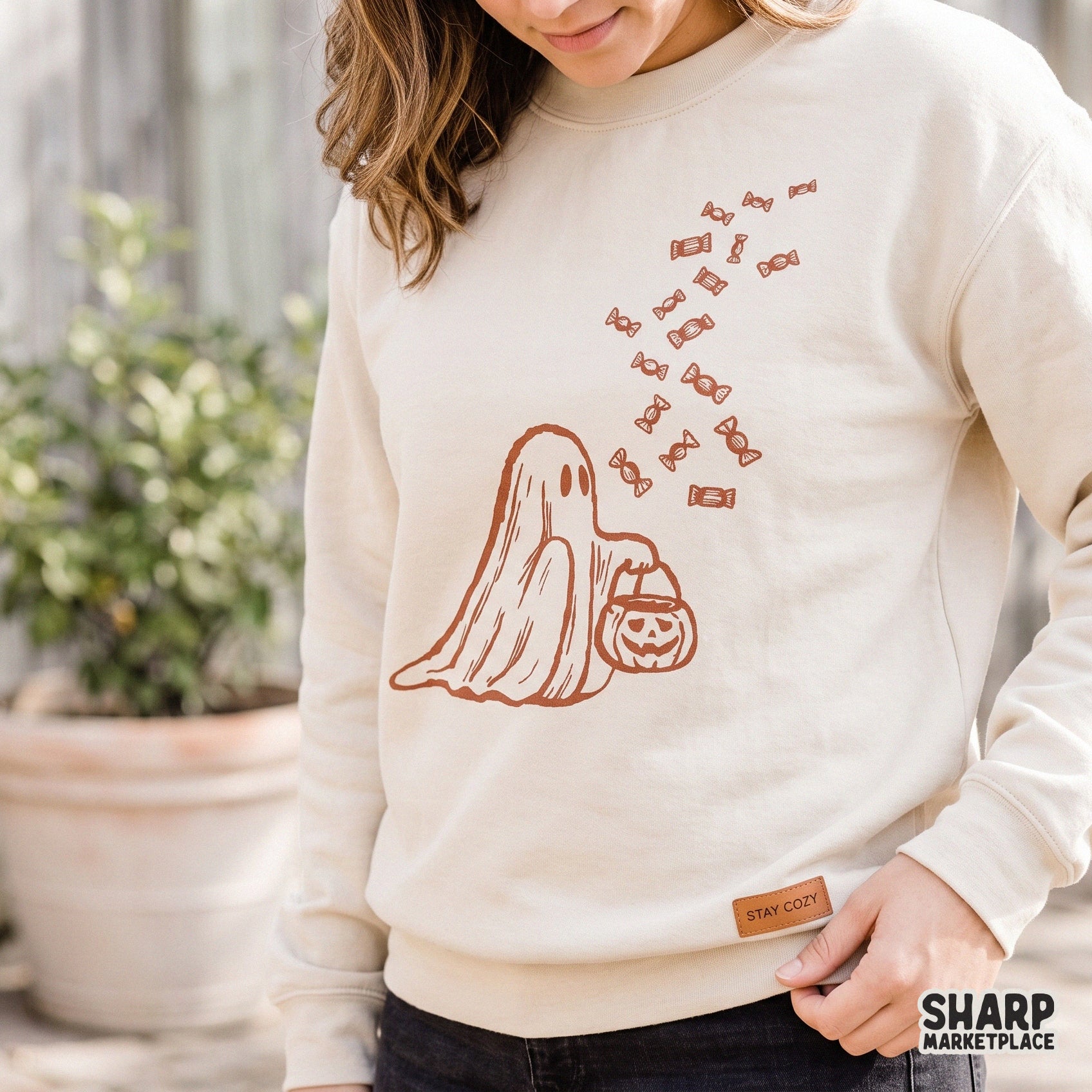 Retro Halloween ghost holding a trick or treat candy bucket PNG for spooky season tumbler wraps and fall apparel designs