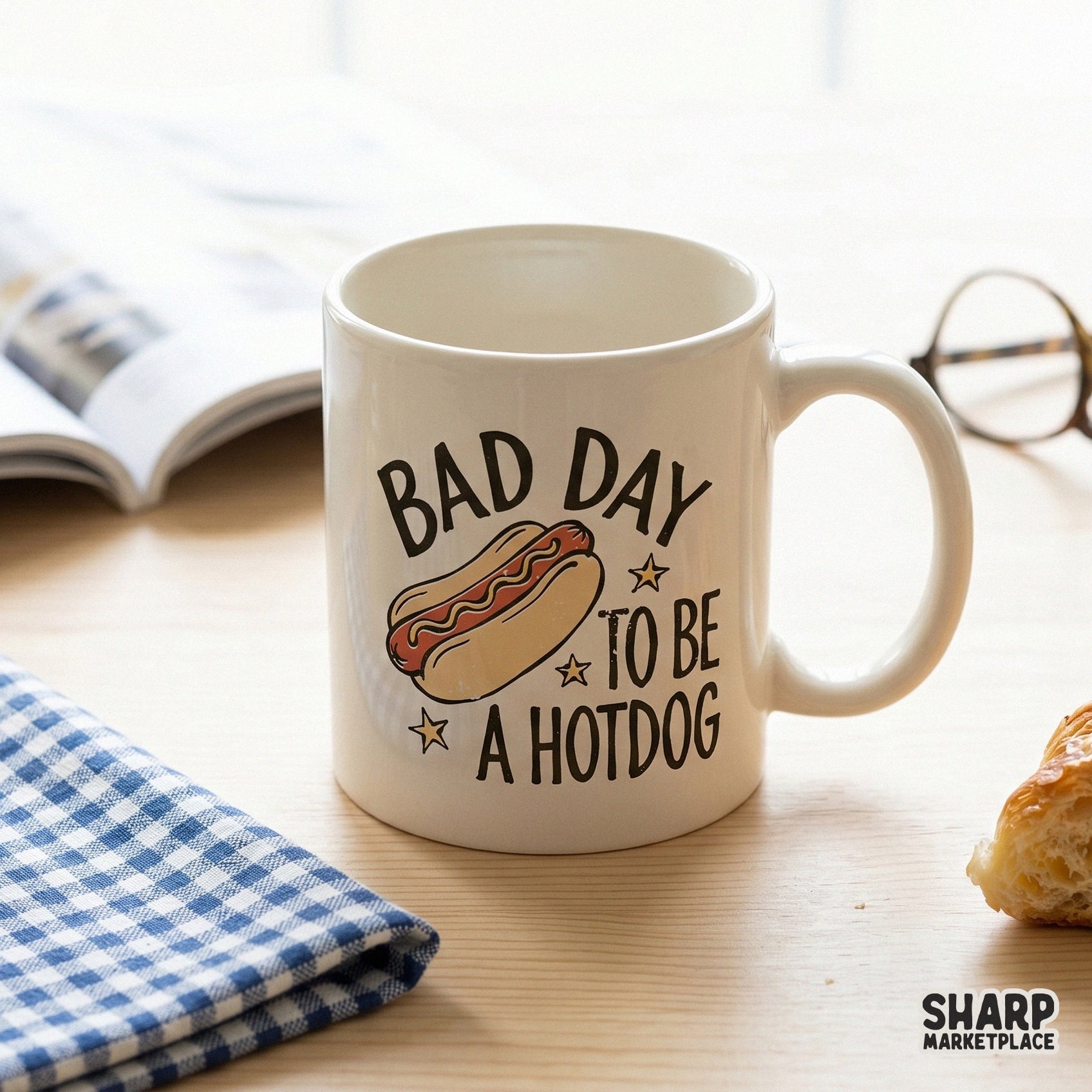 A coffee mug mockup displaying a vintage-inspired graphic of a hotdog with mustard and the humorous quote Bad Day To Be A Hotdog.