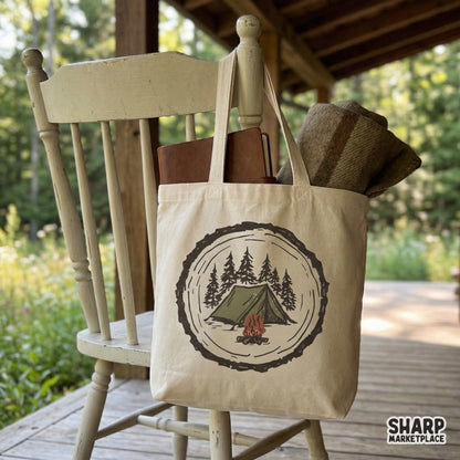Cozy wilderness badge graphic featuring a tent and campfire in a wood slice, ideal for nature-inspired DIY crafts, mugs, and apparel prints.