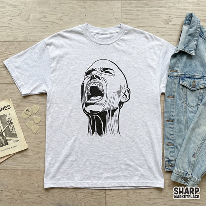 A high-contrast black and white sketch of a person screaming with an open mouth, featured as a graphic print on a light grey heather t-shirt.