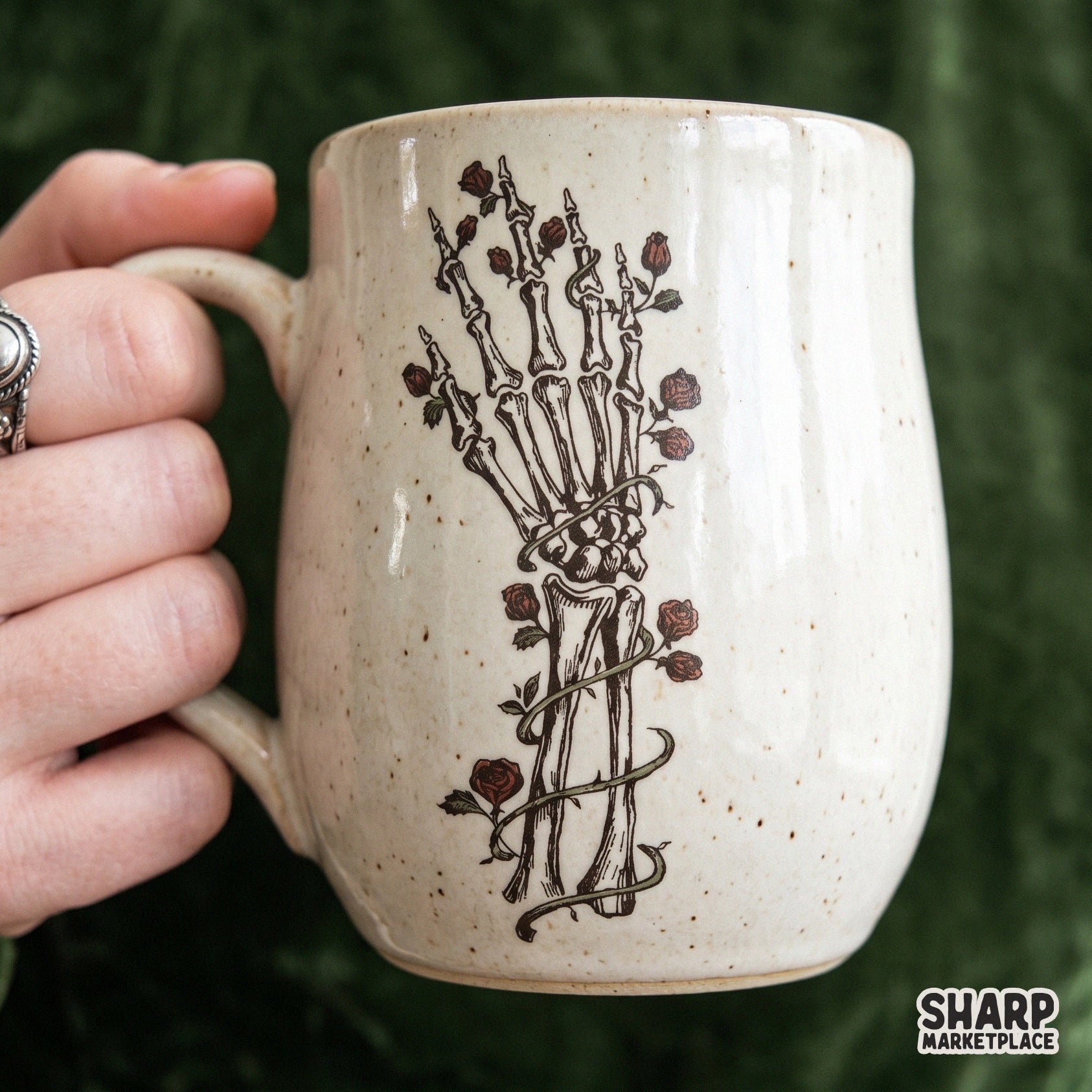 Vintage skeleton hand holding red roses in a gothic botanical skull design for Halloween shirt sublimation prints