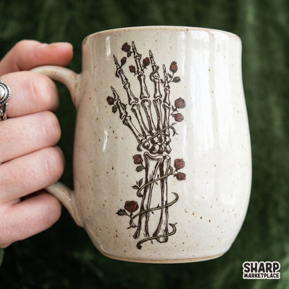 Vintage skeleton hand holding red roses in a gothic botanical skull design for Halloween shirt sublimation prints