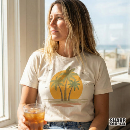 A vintage-style palm tree sunset graphic printed on a cream-colored t-shirt, perfect for summer vacation apparel and sublimation projects.