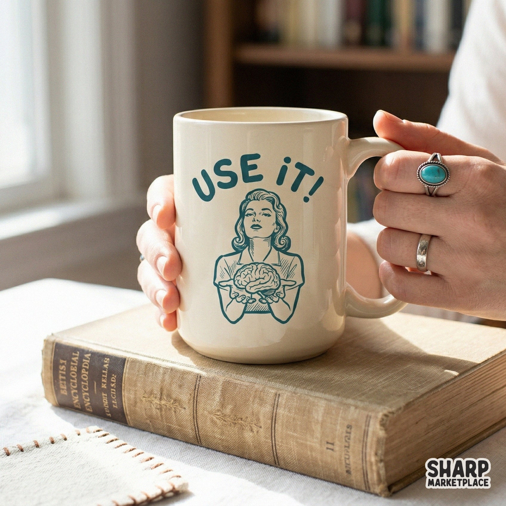 A ceramic mug featuring a vintage-style teal illustration of a woman holding a brain with the witty text Use It, ideal for custom drinkware projects.