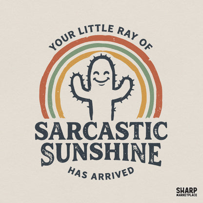 Retro-style digital design featuring a smiling cactus inside a muted rainbow with the text Your Little Ray Of Sarcastic Sunshine Has Arrived.