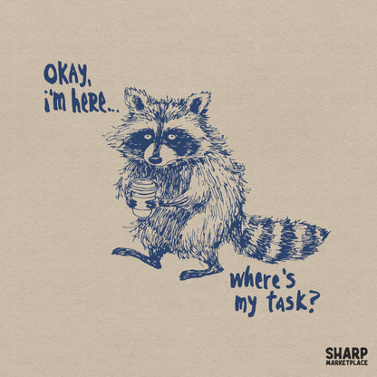 Hand-drawn navy blue illustration of a tired raccoon holding a coffee cup with the text Okay, I'm Here... Where's My Task? in a casual font.