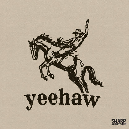 Vintage style black ink illustration of a cowboy on a bucking bronco with the word Yeehaw in bold serif font, isolated on a neutral background.