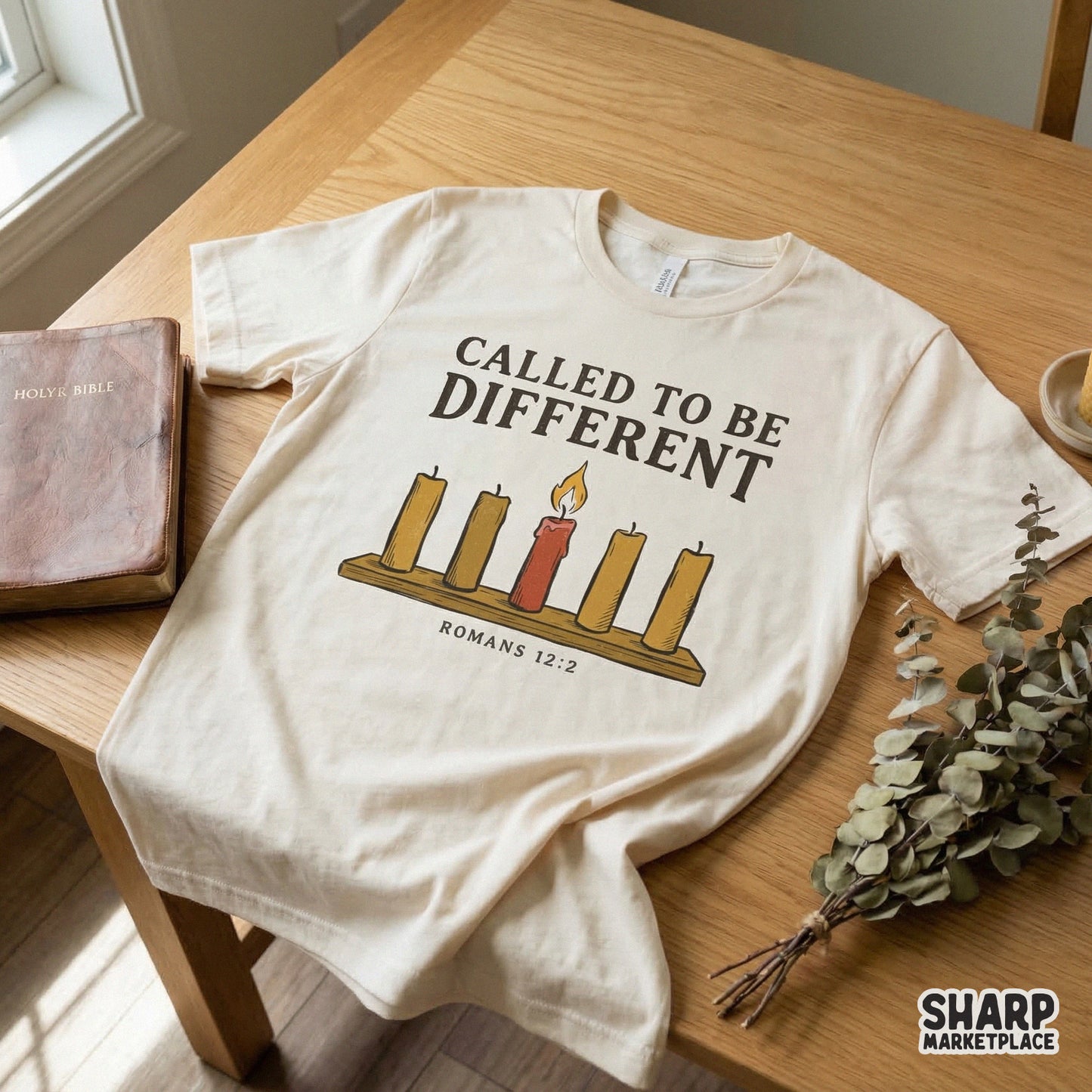 Apparel design featuring five candles on a wooden base with a single lit red candle, text reads Called To Be Different with Romans 12:2, for sublimation.