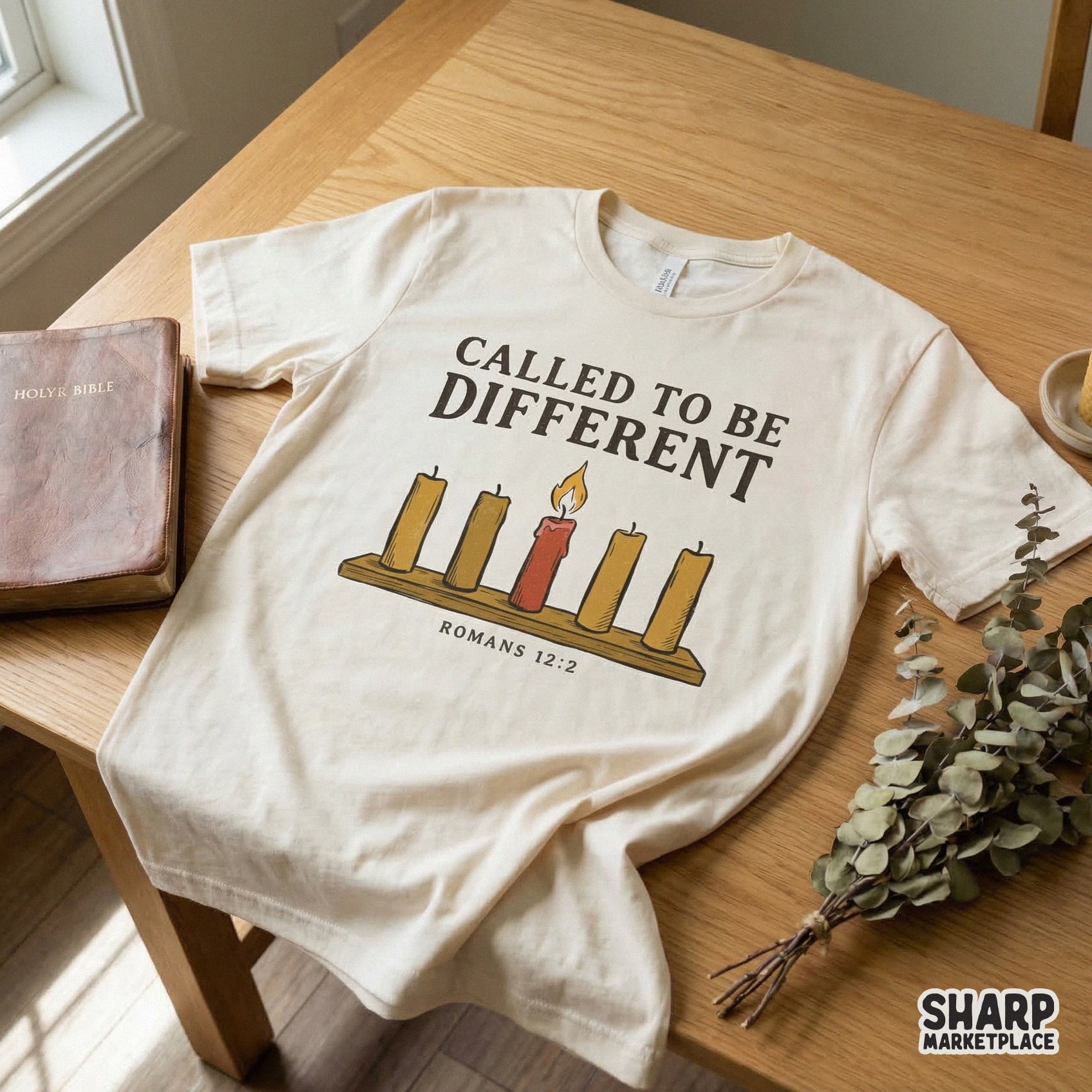 Apparel design featuring five candles on a wooden base with a single lit red candle, text reads Called To Be Different with Romans 12:2, for sublimation.