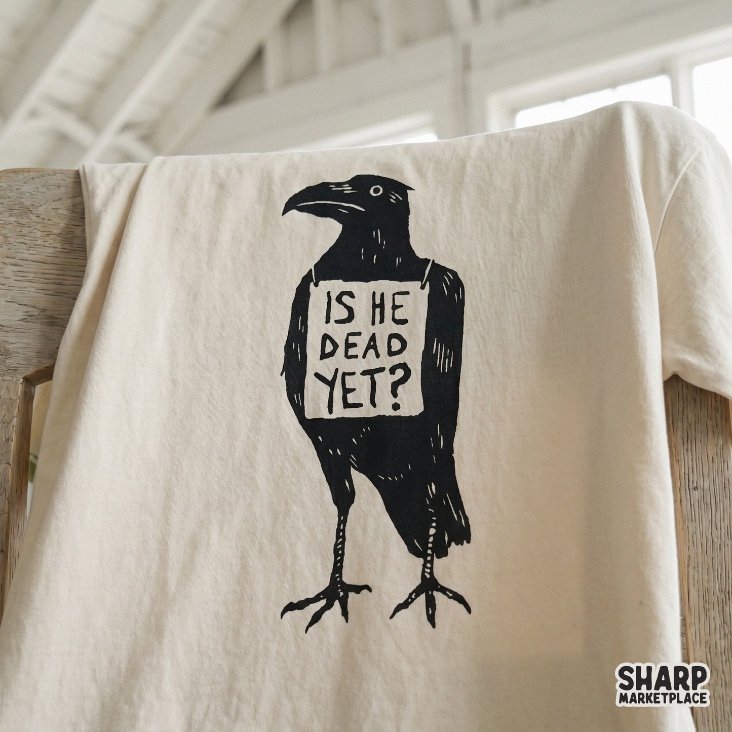 Moody ink-style crow illustration featuring the quote Is He Dead Yet, a high-contrast digital design for DTF transfers and spooky Halloween printables.