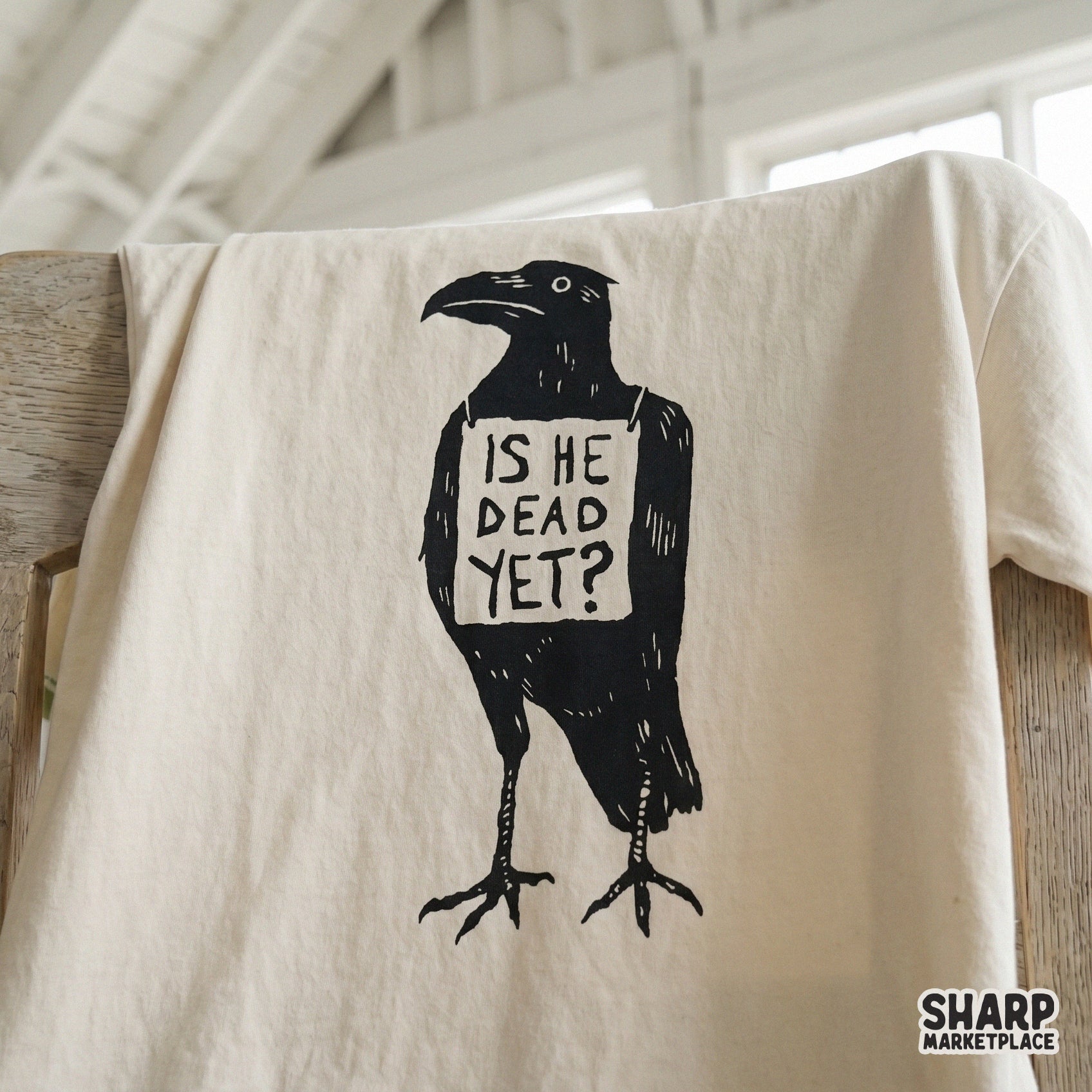 Moody ink-style crow illustration featuring the quote Is He Dead Yet, a high-contrast digital design for DTF transfers and spooky Halloween printables.