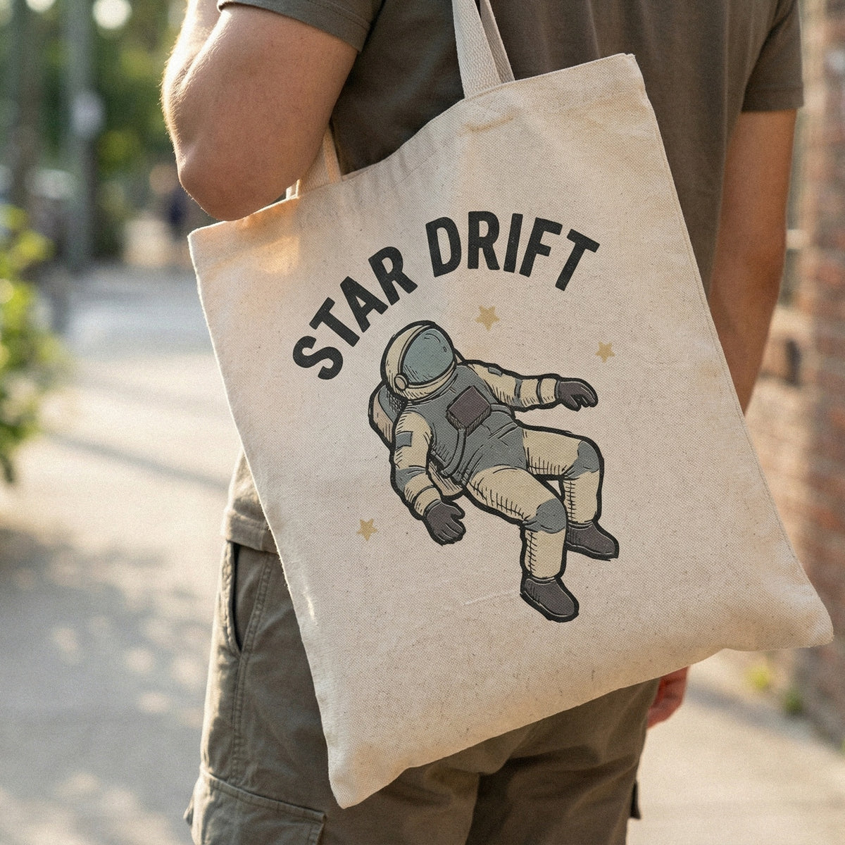 Celestial astronaut illustration with Star Drift lettering, a versatile digital download for creating unique galaxy-themed apparel and craft projects.