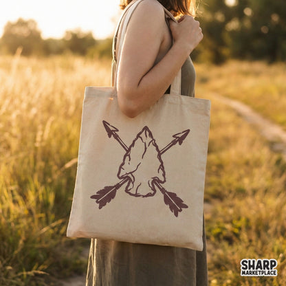 Hand-chipped stone arrowhead with crossed arrows in a vintage style, suitable for direct-to-garment printing on outdoor apparel and DIY western gifts.