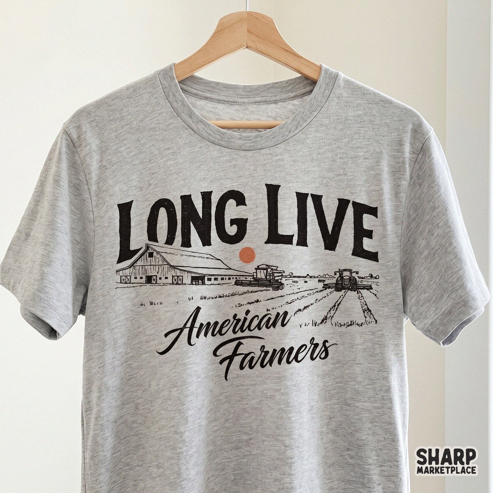 Rustic farm life graphic on a grey t-shirt mockup showing a barn, tractor, and combine harvester with vintage typography for country apparel.