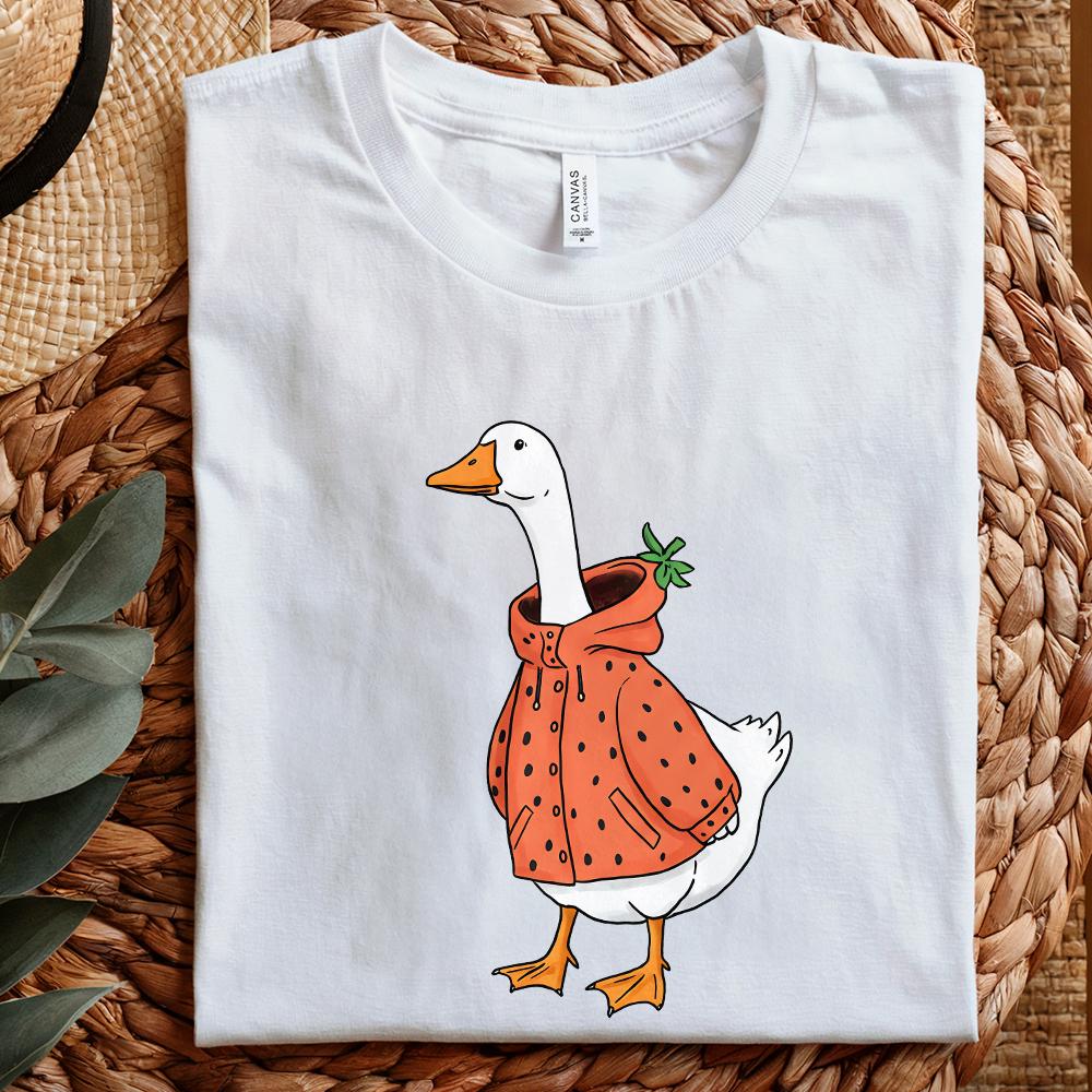 Playful cottagecore goose illustration with a strawberry raincoat, ideal for sublimation tumblers, apparel, and trendy print-on-demand.