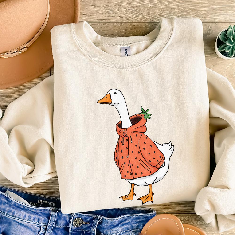 Charming white goose wearing a strawberry-themed raincoat, a versatile digital download for custom t-shirts and spring-inspired crafts.