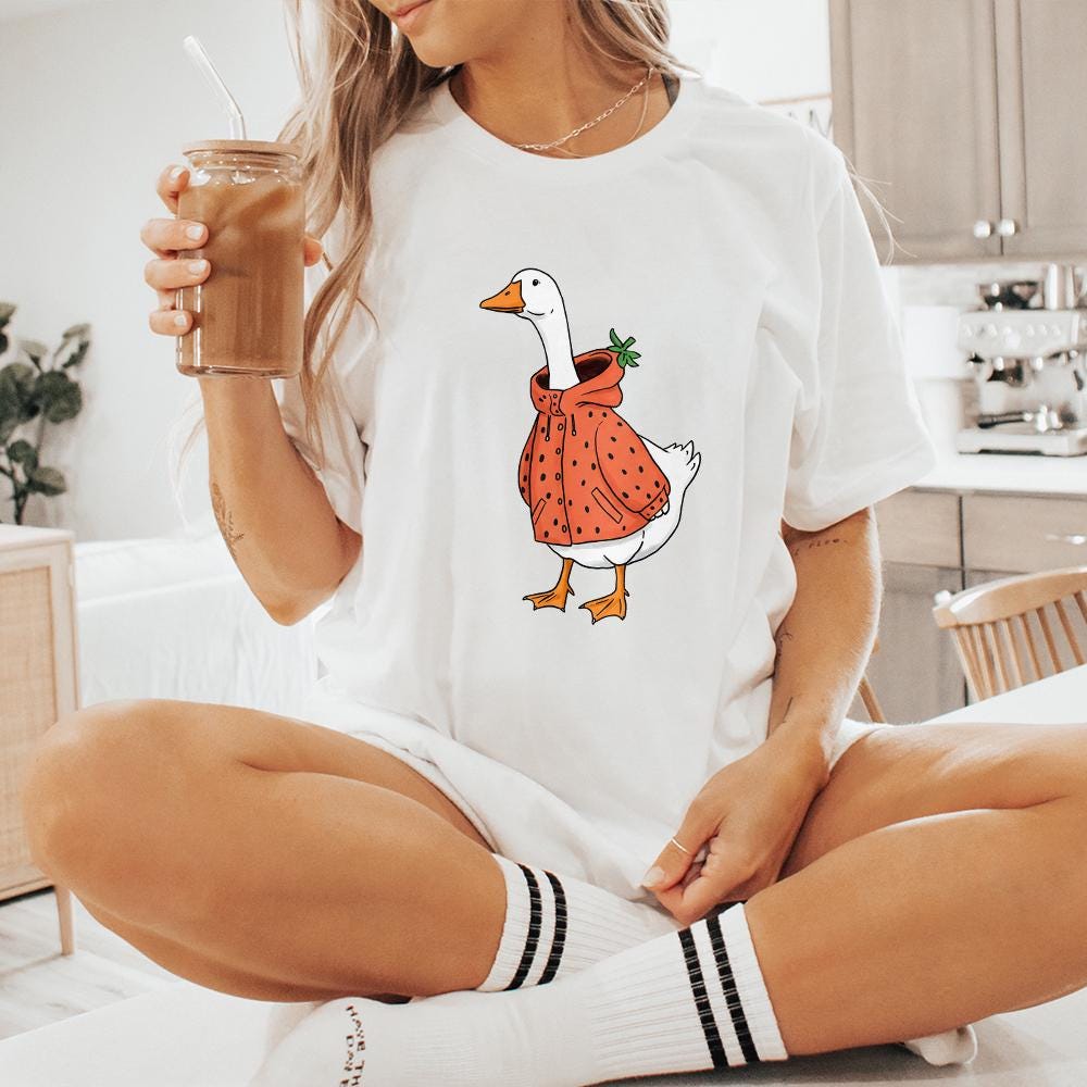 Cozy cottagecore design of a silly goose in a strawberry jacket, ideal for DTF printing, heat transfers, and personalized accessories.