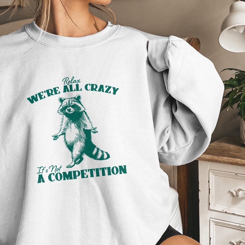 Relax We're All Crazy It's Not A Competition PNG, Funny Raccoon Design -