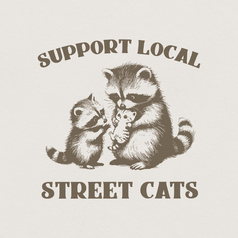 Vintage style Support Local Street Cats graphic featuring a mother raccoon holding a kitten with a baby raccoon, in monochromatic brown.